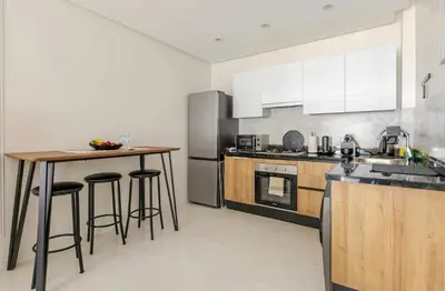 a kitchen with a table and some bar stools at Atlantic Suite View 1 in Casablanca