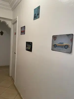 a white wall with pictures of a car on it at Private room in Casablanca