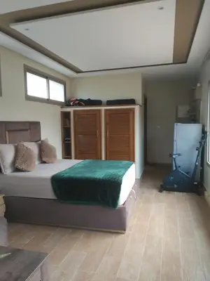 a bedroom with a large bed and a window at Lake House Boulaouane in El Jadida