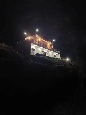 a house on top of a hill at night at Lake House Boulaouane in El Jadida