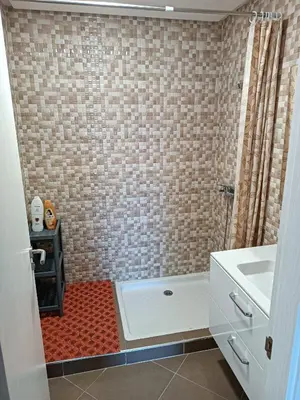 a bathroom with a shower and a sink at Appartement avec piscine à Mohammedia Plage à 5min in Mohammedia