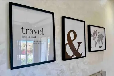 three framed pictures hanging on a wall at Cosy Apartment with sea view in Sidi Rahal