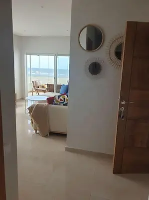 a living room with a couch and a mirror at Appartement Front de mer avec vue Panoramique in Casablanca