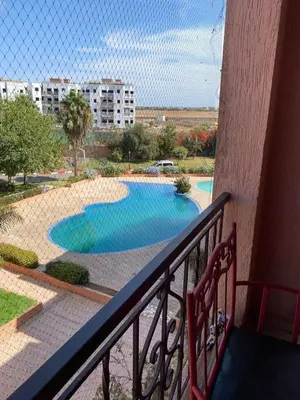 a balcony with a view of a swimming pool at Appartement mohamedia Ricoflores vue sur piscine in Mohammedia