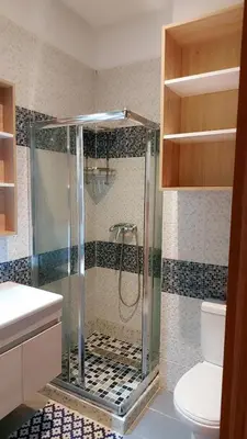 a bathroom with a shower and a toilet at Appartement Costa Bouznika in Bouznika