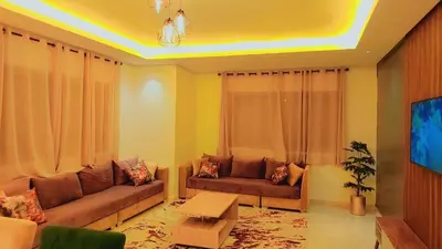 a living room with a couch and a table at Appartement Costa Bouznika in Bouznika
