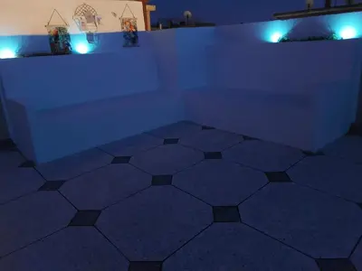 a room with blue lights and a tiled floor at Cosy appartement proche de l'aéroport mohamed 5 in Deroua