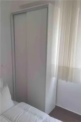 a bedroom with a bed and a window with a curtain at Joli Studio au Centre Ville avec WIFI - Netflix in Casablanca
