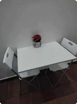 a white table with two chairs and a vase on it at Joli Studio au Centre Ville avec WIFI - Netflix in Casablanca