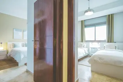 an open door to a bedroom with two beds at lovely 2 bedroom vacation home with pool/beach in Skhirat