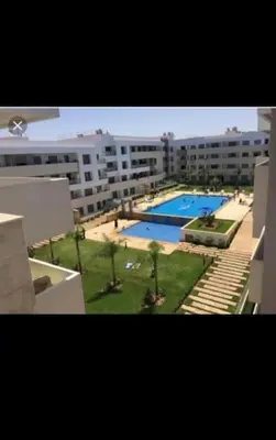 a view of a large apartment complex with a swimming pool at Les perles de mimosa Mohammédia in Mohammedia