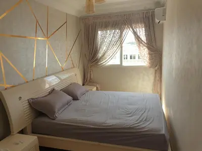 a small bedroom with a bed and a window at Appartement Meublé AIN SEBAA in Aïn Sebaa