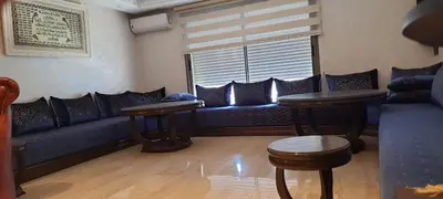 a living room with a blue couch and a window at Casa Fainna in Casablanca