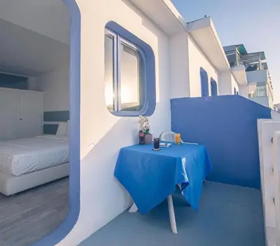 a small blue table in a room with a bed at Hotel Tropicana in Casablanca