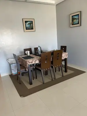 a dining room with a table and chairs at Eden tamaris résidence in Dar Bouazza