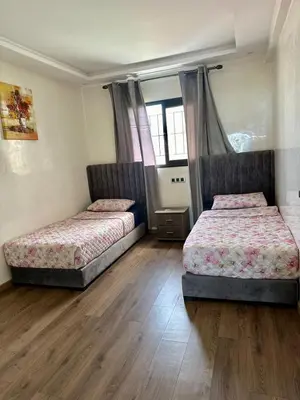 two beds in a room with wooden floors at sea view appart and roof top, jack beach Tamaris, Dar Bouaza in Casablanca