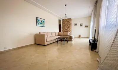a living room with a couch and a table at Ferme d'hôte Evasio in Sidi Rahal