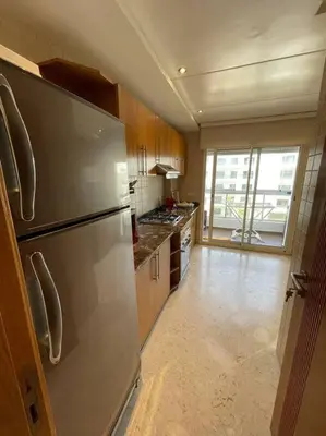 a kitchen with a stainless steel refrigerator at Appartement de luxe à peninsula in Casablanca
