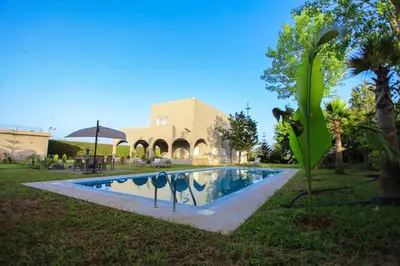 a swimming pool in the yard of a house at Villa in Rabat in Oulad Mbark