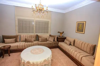 a living room with a couch and a table at Villa in Rabat in Oulad Mbark