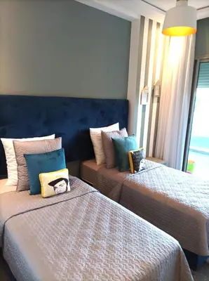 a bedroom with two beds with pillows on them at Amwaj Beach Sidi Rahal in Casablanca