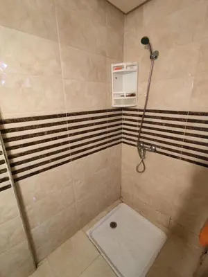 a shower in a bathroom with a shower at Molto carino ben solare in Sidi Rahal