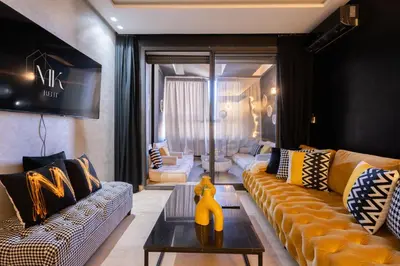 a living room with two couches and a table at La terrasse d'Audrey - Short stay au coeur du Maarif in Casablanca