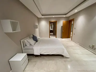 a bedroom with a large white bed in a room at Luxury Villa Oasis, Bouznika Bay in Bouznika