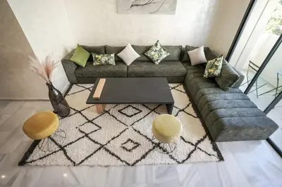 a living room with a couch and a table at Luxury Prestigia 2Bed Rooms in Rabat
