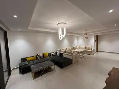 a living room with a couch and a table at Appartement Ocean View - Marina Casablanca in Casablanca
