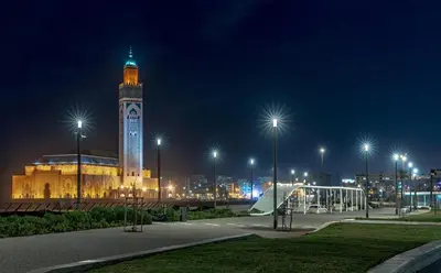 a building with a clock tower at night at Horizon Appartement Playa in Casablanca