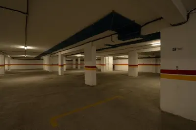 an empty parking lot with white columns in a parking garage at Pop Art Studio-Location Journalière Casablanca in Casablanca