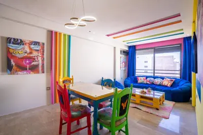 a living room with a table and chairs and a couch at Pop Art Studio-Location Journalière Casablanca in Casablanca