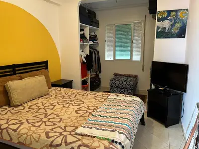 a bedroom with a bed and a flat screen tv at Apparemment déjà vendu ne réserve pas in Azemmour