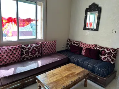 a living room with a couch and a table at Apparemment déjà vendu ne réserve pas in Azemmour