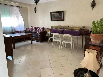 a living room with a couch and a table and chairs at Apparemment déjà vendu ne réserve pas in Azemmour