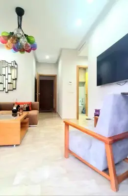 a living room with a couch and a tv at Appartement Casablanca in Dar Bouazza