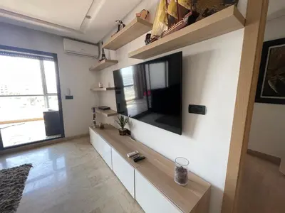 a living room with a flat screen tv on a wall at La perle corniche in Casablanca