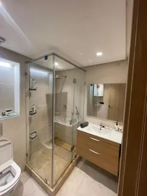 a bathroom with a shower and a sink and a toilet at La perle corniche in Casablanca