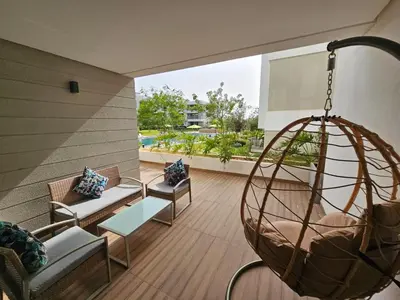 a living room with a hanging chair and a swing at Superbe Appartement Green Town in Oulad Lahsene