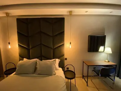 a bedroom with a large bed with a desk and a desk at Glamorous Habous - By AppartAli in Casablanca