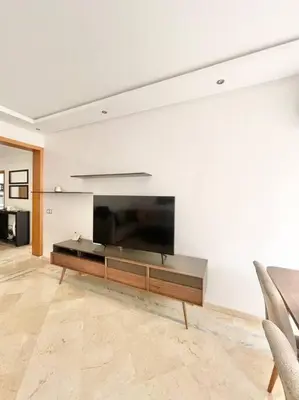 a living room with a large flat screen tv on a wall at Appartement Cozy au Triangle d’or in Casablanca