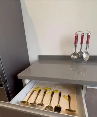 a refrigerator with many cooking utensils in a drawer at 2 Bed Apartment - Balcony Parking Wifi in Casablanca