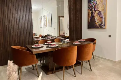 a dining room with a table and chairs at 2 Bed Apartment - Balcony Parking Wifi in Casablanca