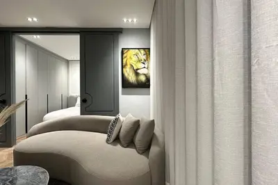 a bedroom with a couch and a lion painting on the wall at Touch of Luxury - By AppartAli in Casablanca