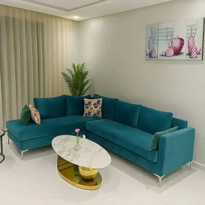 a living room with a blue couch and a table at maarif elite suite in Casablanca