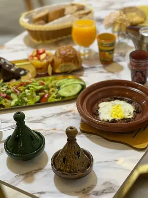 a table with a plate of food and a plate of food at maarif elite suite in Casablanca