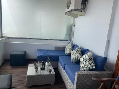 a living room with a blue couch and a table at Panoramic View from 14th floor in Casablanca