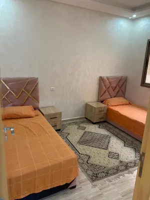 two beds sitting in a room with at Chez Soad in Bouznika