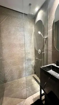 a bathroom with a glass shower with a sink at The Address - Sunny Anfa Hills in Casablanca